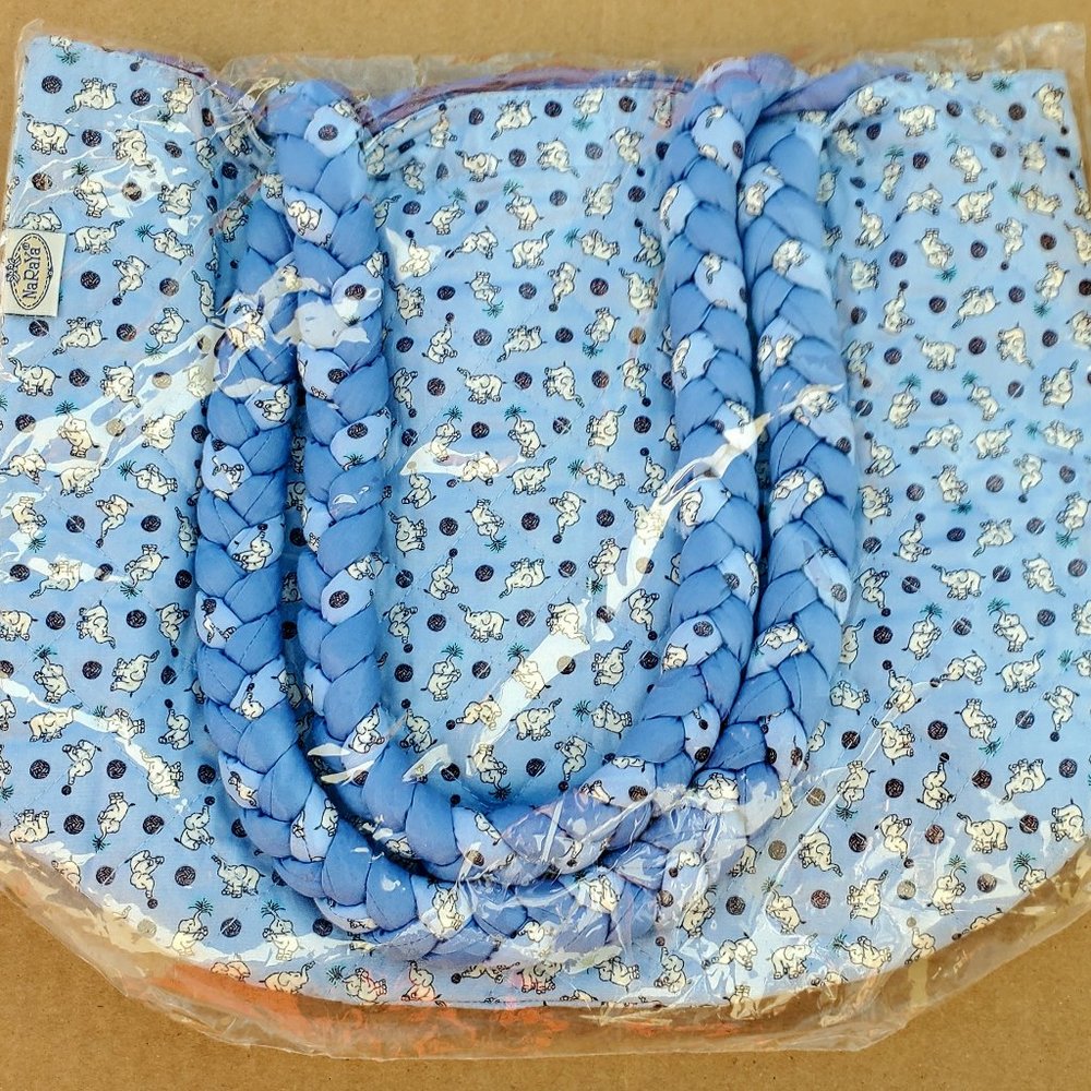 .Blue cloth tote with small, adorable elephant print.